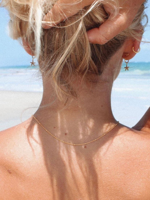 Gold Beaded Necklace on Model.
